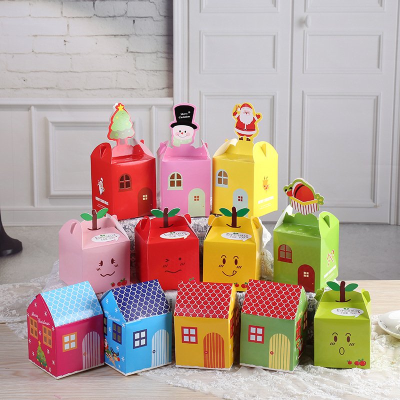 Assorted colorful gift boxes designed like houses and fruit with festive accents.