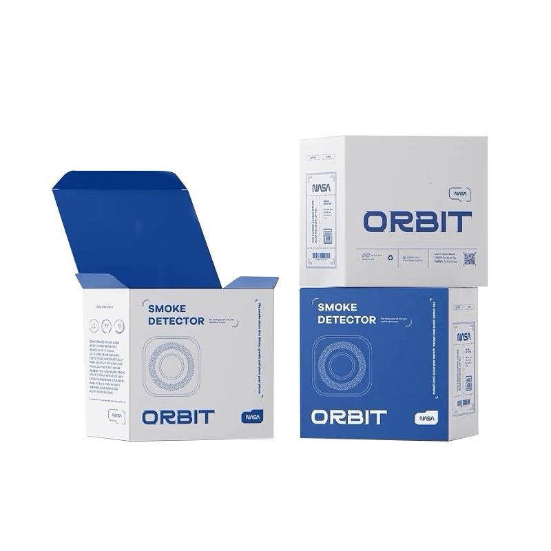 White and blue ORBIT smoke detector packaging with multiple views, including an open box.