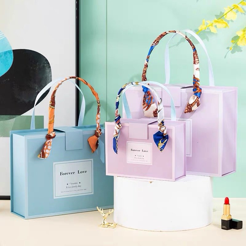 Elegant pastel gift bags with decorative scarf handles.