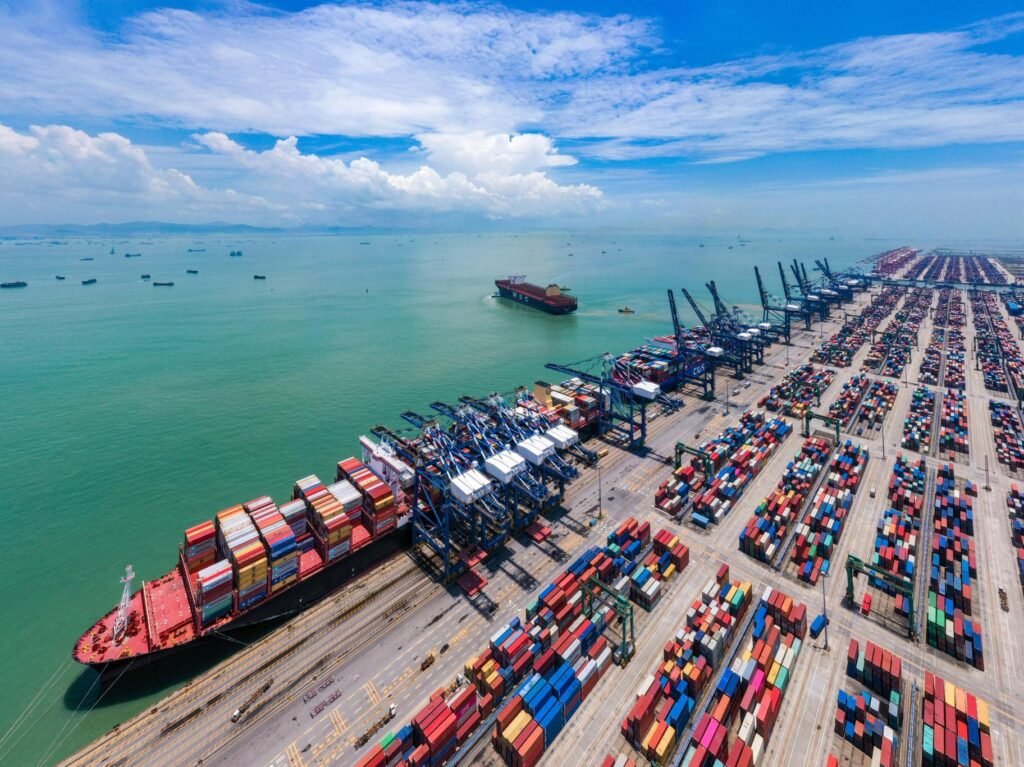 Busy shipping port with colorful cargo containers and a container ship.