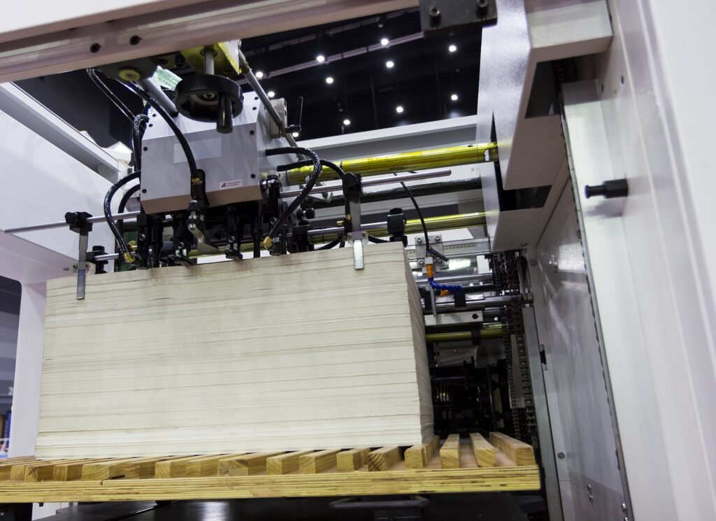 A fully automatic die-cutting machine in action, precisely cutting shapes from sheets of material.