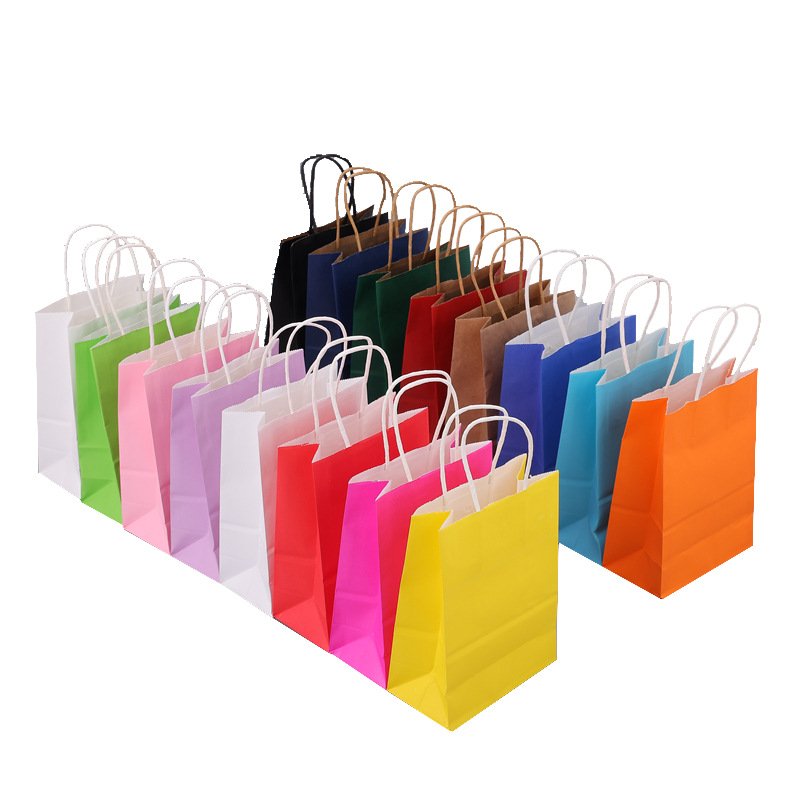 A collection of colorful paper gift bags with rope handles in various shades arranged in rows.