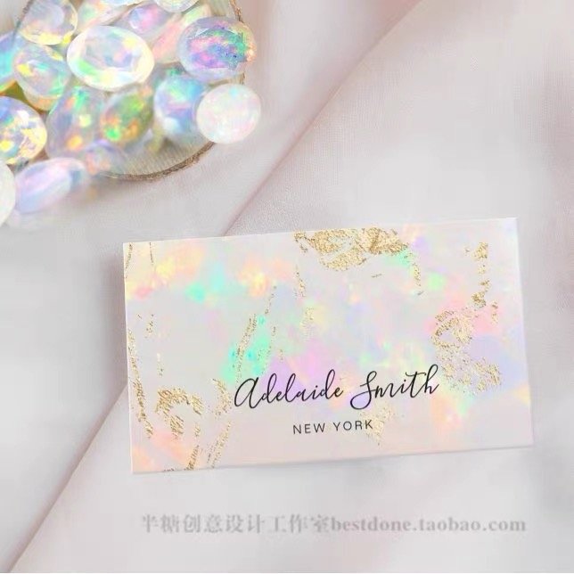 Elegant holographic business card with gold accents and cursive text.